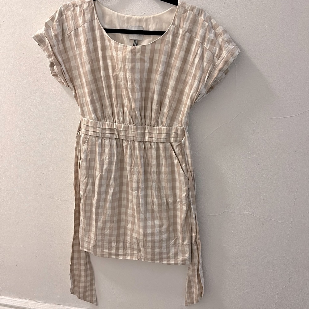 Cute cream plaid sun dress with tie sash and pockets!